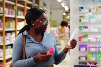 Young woman choosing deodorant